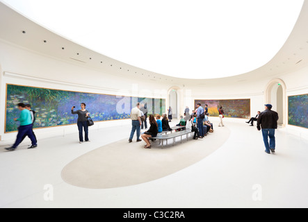 Touristen sehen die Wasserlillies von Claude Monet in der Orangerie Galerie, Tuilerien Garten, Paris Stockfoto