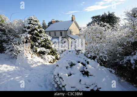 Landhaus, Wintergarten und Schnee bedeckt Garten an einem kalten Tag in East Devon Stockfoto