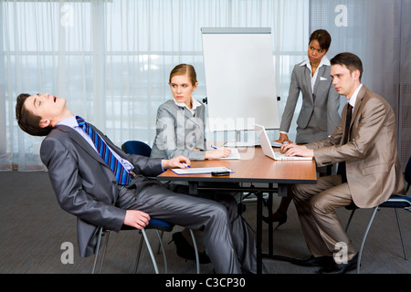 Foto von unzufrieden Geschäftsleute streng betrachtet man Schnarchen Mann bei Präsentation Stockfoto