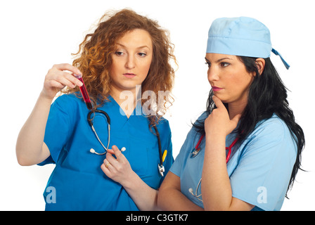 Zwei Ärzte Frauen analysieren Blut Rohr und mit Gespräch isoliert auf weißem Hintergrund Stockfoto