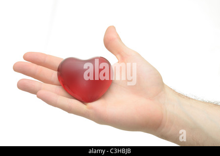Eine Hand hält ein Herz Stockfoto
