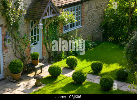 Weg über Rasen eingefasst mit Box Hecke zu Ferienhaus Veranda im englischen Garten Stockfoto