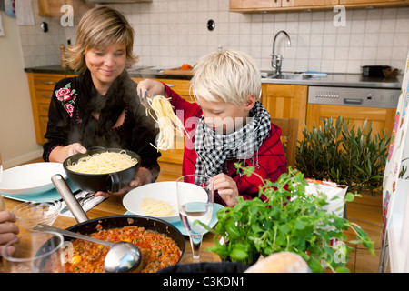 Mutter und Sohn Spaghetti-Essen Stockfoto