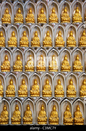 Eine Wand aus kleinen Buddha-Statue Stockfoto