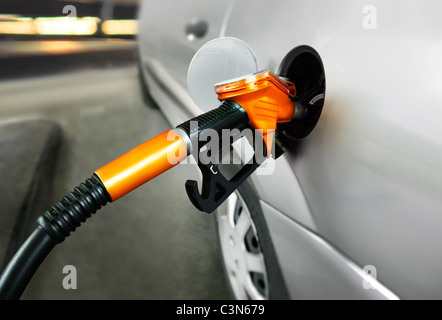 graues Auto an Tankstelle mit Kraftstoff gefüllt Stockfoto