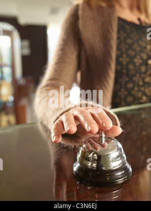 Nahaufnahme von Frau ringin eine Hotel-Träger-Glocke Stockfoto