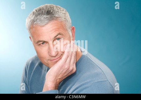 Graue Haare Mann mit Kopfstütze in der hand Stockfoto