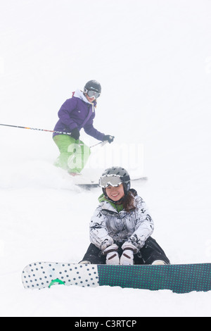 Skifahrer und Snowboarder auf der Piste Stockfoto