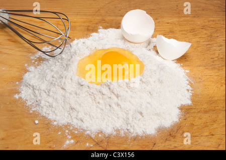 Eine einzelne Eigelb in einem Bett aus Mehl kochen. Stockfoto