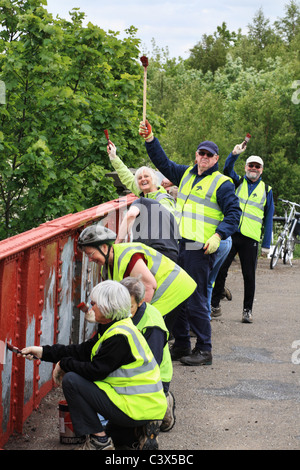 Sustrans freiwillige Förster arbeiten an der Küste zu Küste C2C Radweg Malerei eine Brücke in Stanley, Co Durham, NE, England, Grossbritannien Stockfoto