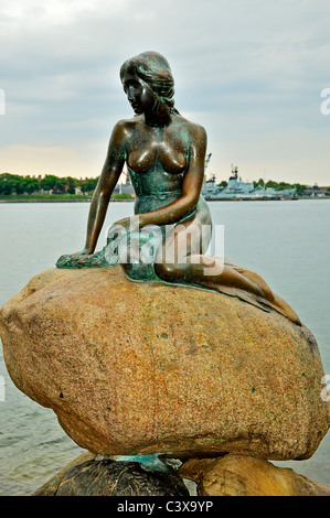 Die Bronze-Skulptur der kleinen Meerjungfrau sitzt auf einem großen Felsen in Ufernähe am Kreuzfahrt-Schiff-Hafen, Copenhagen Stockfoto