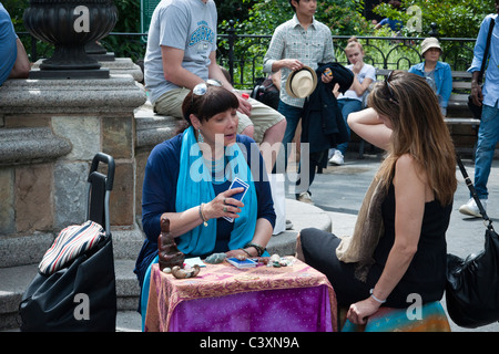 Eine Wahrsagerin liest Karten um eine Frau was in Union Square Park in New York erwartet zu informieren Stockfoto