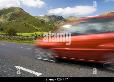 Rotes Auto, Straße A592 Lake District National Park, UK zu beschleunigen
