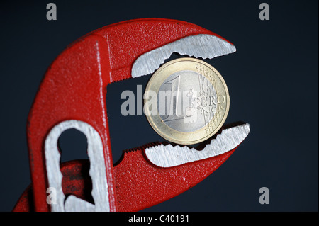1-Euro-Münze in einen verstellbaren Schraubenschlüssel Stockfoto