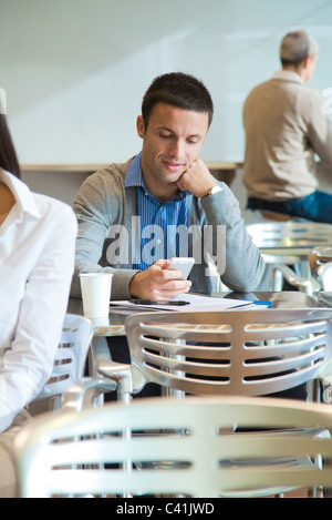 Mann mit Handy in cafeteria Stockfoto