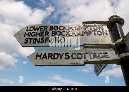 Eine alte hölzerne Wegweiser den Weg zu Thomas Hardy's Cottage, Higher Bockhampton und stinsford Church, wo er begraben liegt, Dorset, England. Stockfoto