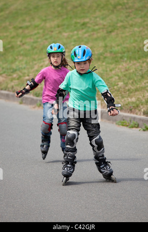 Bruder und Schwester Inline-Skaten zusammen Stockfoto