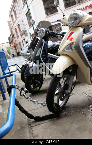 Einem geparkten Roller sicher angekettet in einer Straße U.K. Stockfoto