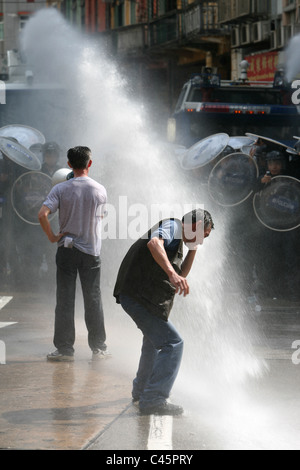 Männer protestiert und bekommt von Polizei Wasserwerfer getroffen Stockfoto