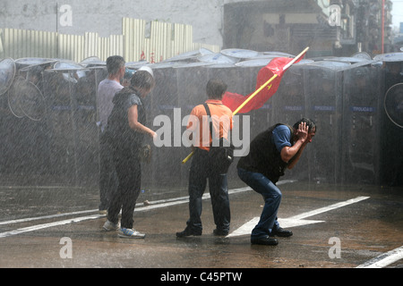 Männer protestiert und bekommt von Polizei Wasserwerfer getroffen Stockfoto