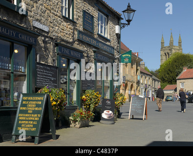 Unabhängige lokale Geschäfte Geschäfte Market Place von Borogate und All Saints Church Helmsley North Yorkshire England Großbritannien GB Großbritannien Stockfoto