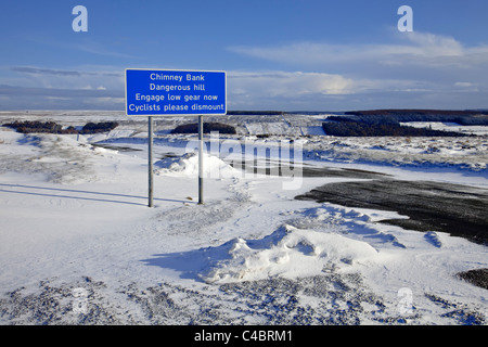 Straßenschild an Spitze der Rosedale Schornstein Bank auf North York Moors in schweren Winterbedingungen, Angabe eines gefährlichen Abstiegs Stockfoto