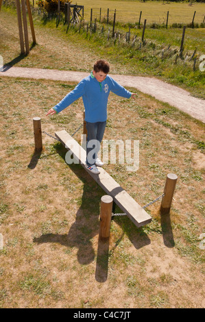 Ein elfjähriger Junge, balancieren auf dem Spielpark in Westleton, Suffolk, England, Großbritannien, Uk Stockfoto