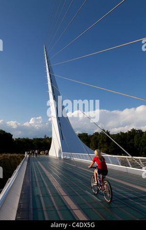 Frau Reiten Fahrrad auf Sundial Bridge im Turtle Bay, Redding, Kalifornien. Von Santiago Calatrava entworfen. Stockfoto