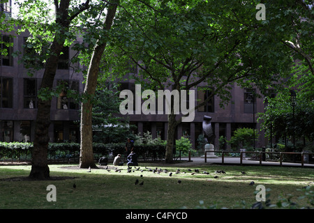 Entspannen Sie in einem kleinen Garten der Victoria Street sind drei Obdachlose Männer und in das gemeinsame Unternehmen der lokalen Tauben. Stockfoto