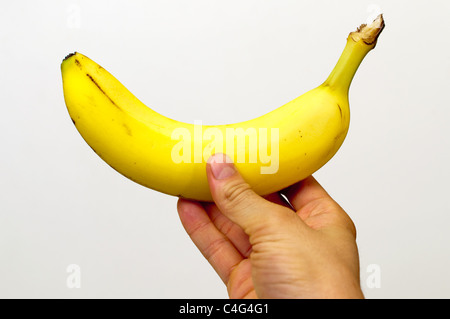 Rechten Hand eine Banane Stockfoto