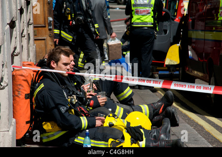 Feuerwehrmann eine Pause bei der Bekämpfung von Feuer bei Aldwych, London, England, UK Stockfoto