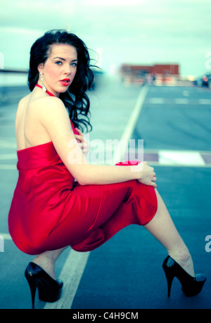 Schöne Frau in High Heels und trägt ein rotes Kleid, London, England, UK. Stockfoto