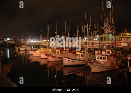 Eine Linie von Segelbooten geparkt über Nacht an einem Pier in San Francisco Fishermans Wharf. Stockfoto