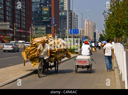 Peking, China, geschäftige Straßenszene im Geschäftsviertel, in der Nähe des Luxus-Einkaufszentrums, Rickshaw-Lieferer, chinesische Stadtstraße, prekäre Arbeit Stockfoto