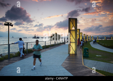 Sonnenuntergang entlang West Kowloon Waterfront Promenade, Kowloon, Hong Kong, China Stockfoto