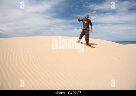 Mann Sandboarding, Jeffreys Bay, Südafrika Stockfoto