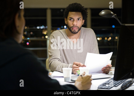 Kolleginnen und Kollegen arbeiten am Projekt zusammen im Büro in der Nacht Stockfoto