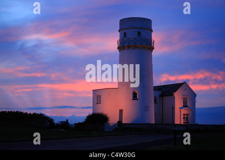 Der Leuchtturm am alten Hunstanton gegen einen farbenfrohen Sonnenuntergang. Stockfoto