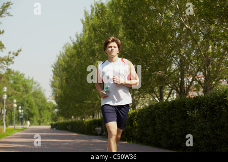 Porträt eines jungen Mannes im Park Joggen Stockfoto