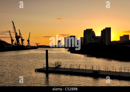 Sonnenuntergang in Glasgow erfüllten Gebäude und Kräne am Horizont Stockfoto