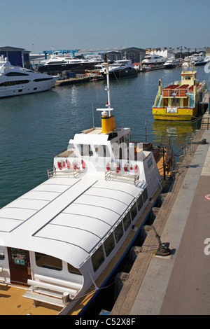 Boote bei Poole Quay mit Sonnenanbeter Boot machen Workshops im Hintergrund im April Stockfoto