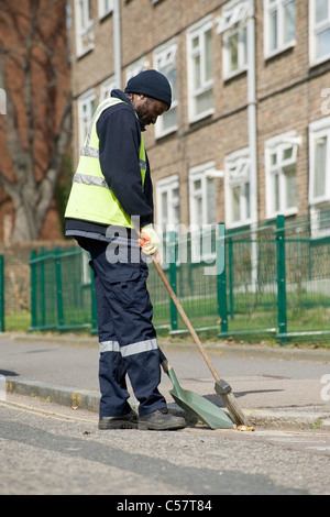 Des Rates Arbeiter kehren einer Straße in einem Vorort von England. Stockfoto