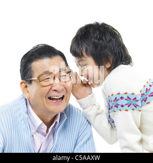 Enkel in Großvaters Ohren flüstern Stockfoto