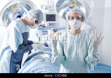 Porträt der Ärztin mit Chirurgen Chirurgie im Hintergrund zu tun Stockfoto
