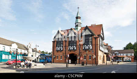 Drei Jugendliche sitzen unter einer Statue von einem Wyvern vor dem alten Rathaus, jetzt ein McDonalds. Bray, Co. Wicklow Irland Stockfoto