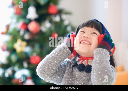 Mädchen ihr Ohrenschützer mit ihren Händen berühren und nachschlagen Stockfoto