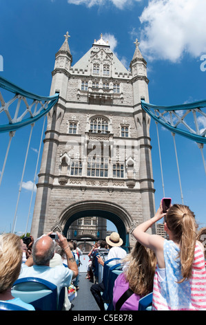 Touristen auf öffnen Top Doppeldecker Original London Tour Bus Kreuzung Tower Bridge, London, UK Stockfoto