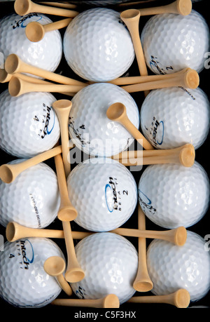 Ein Golf-Themen abstrakte Stilleben, bestehend aus 12 glänzende neue Golf, die Kugeln, symmetrisch gruppiert in Reihen mit Tees vermischt. Stockfoto