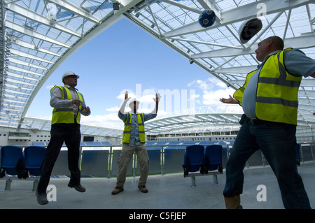 Drei Bauherren mit einem Kick wie Arbeit Fertigstellung auf die neue AMEX Stadion, Heimat von Brighton und Hove Albion Football Club ab 2011 nähert. Stockfoto