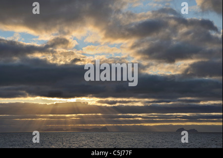 Ozeanische Sonnenuntergang mit den Inseln Vaeroy und Wilholmstind am Horizont, Nord-West-Norwegen. Stockfoto